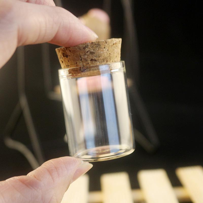 Botella de vidrio transparente de 15 ml con tapa y tapón de madera, cuentas de burbujas y capacidad de 20 ml.