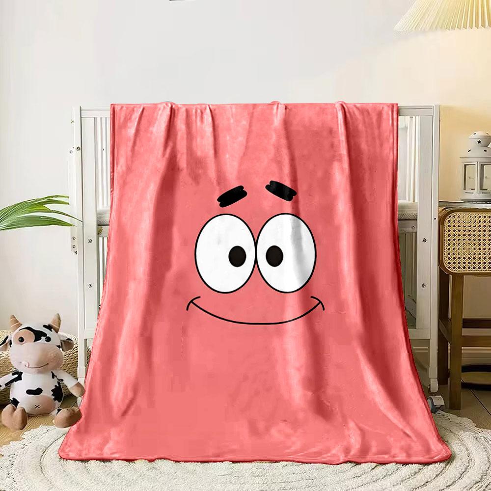A simple pink background with a smiling cartoon face and wide eyes. for all seasons blanket lunch break throw gift