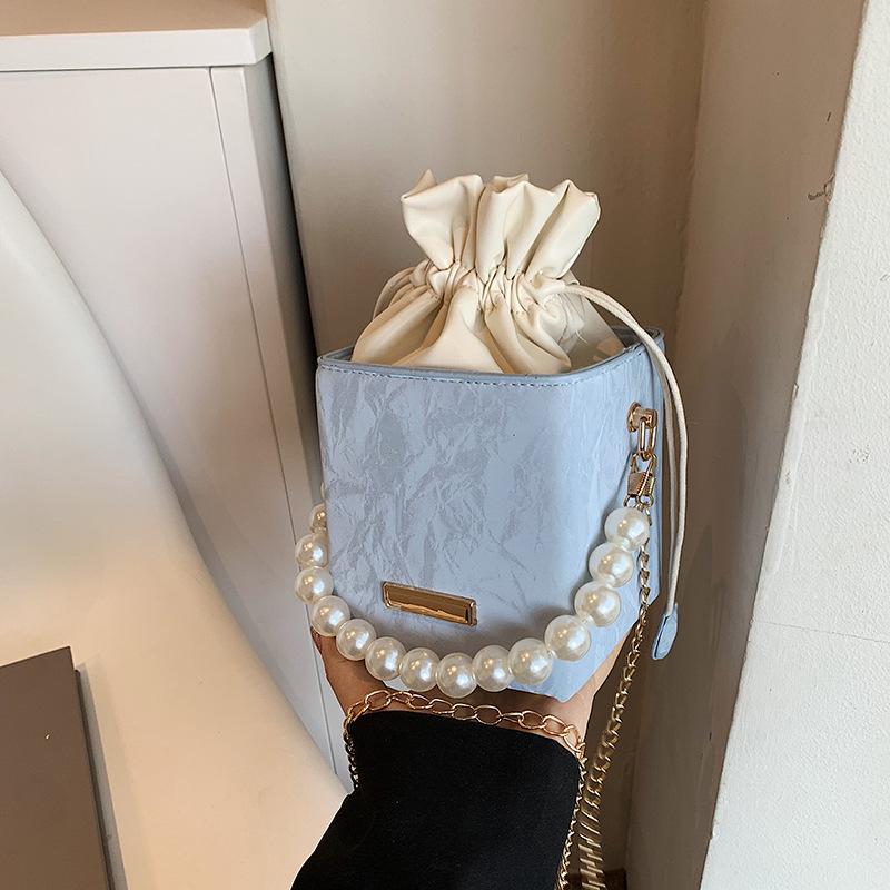 Summer Solid Color 2025 New Personalized Pumping Belt Foreign Leisure Sense Simple Pearl Crossbody Portable Bucket Women's Bag Small