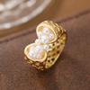 Creative and unique hollowed-out artificial imitation pearl ring made of copper. Suitable for women as a fashionable party gift.