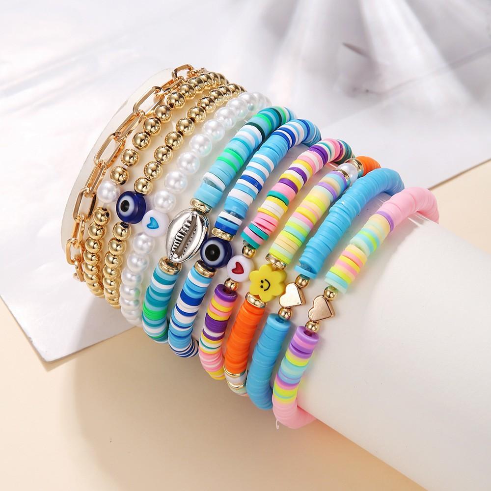 Korean version of fashion new multi-layer elastic thread soft pottery love smiley face bracelet set retro handmade pearl jewelry women