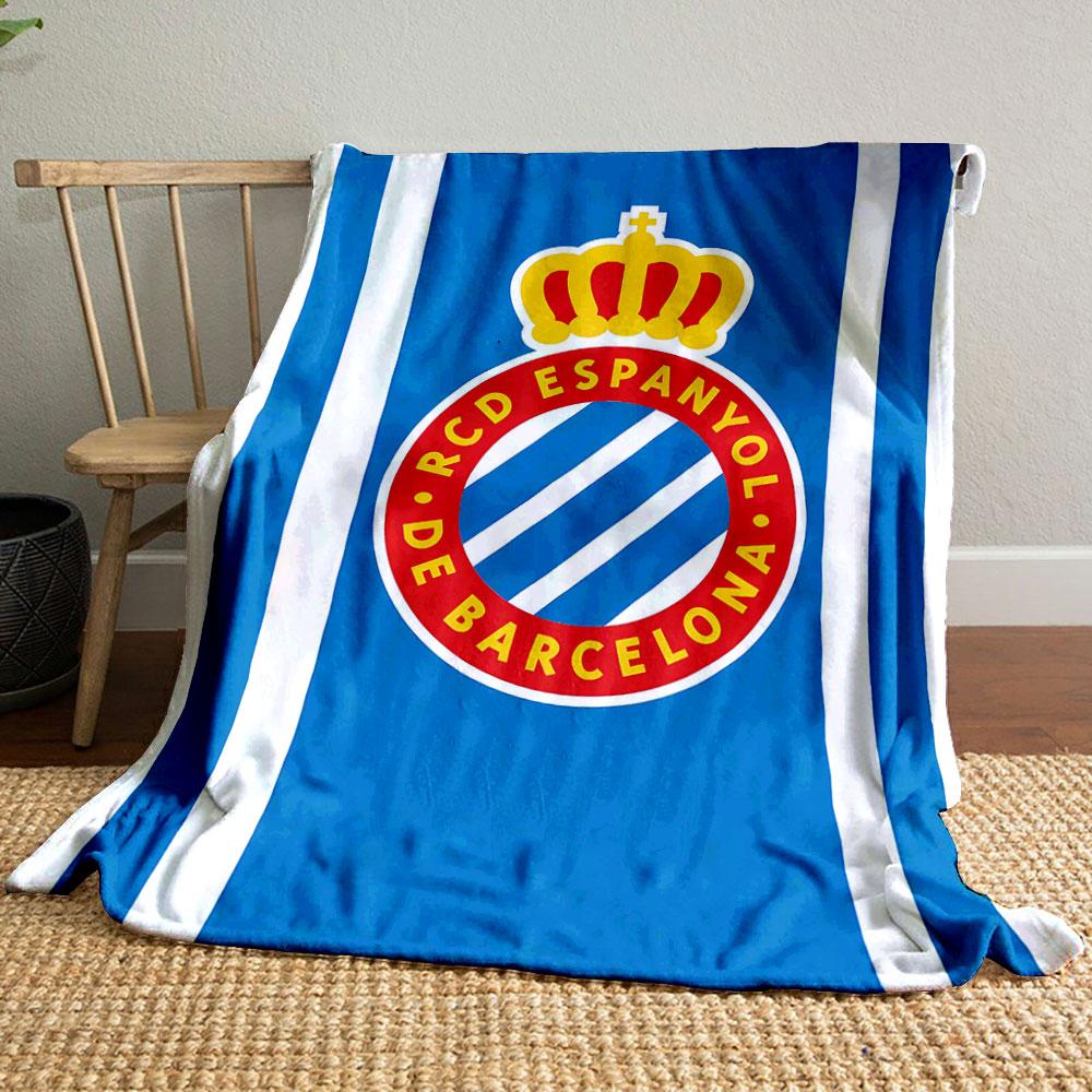 A blue background with white stripes and a crowned red circular emblem. for all seasons blanket lunch break throw gift
