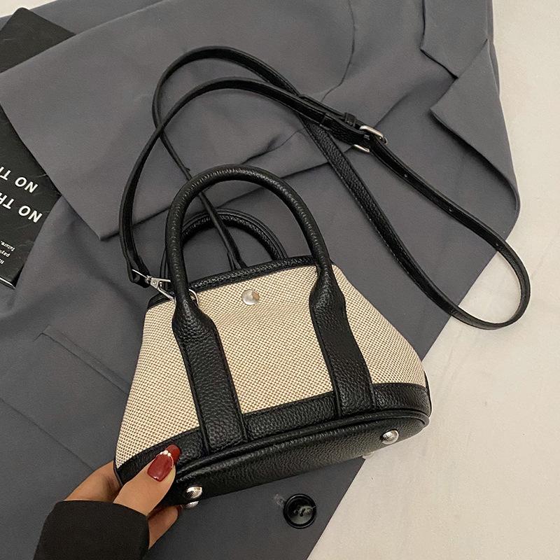 Korean version of casual niche contrasting color splicing portable bucket bag fashion versatile temperament casual commuter messenger bag woman