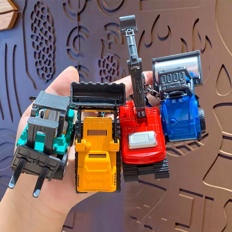 Kreativer Cartoon Mini Bagger Schlüsselanhänger Spielzeug - Perfekt für Rucksäcke oder als Autoanhänger.