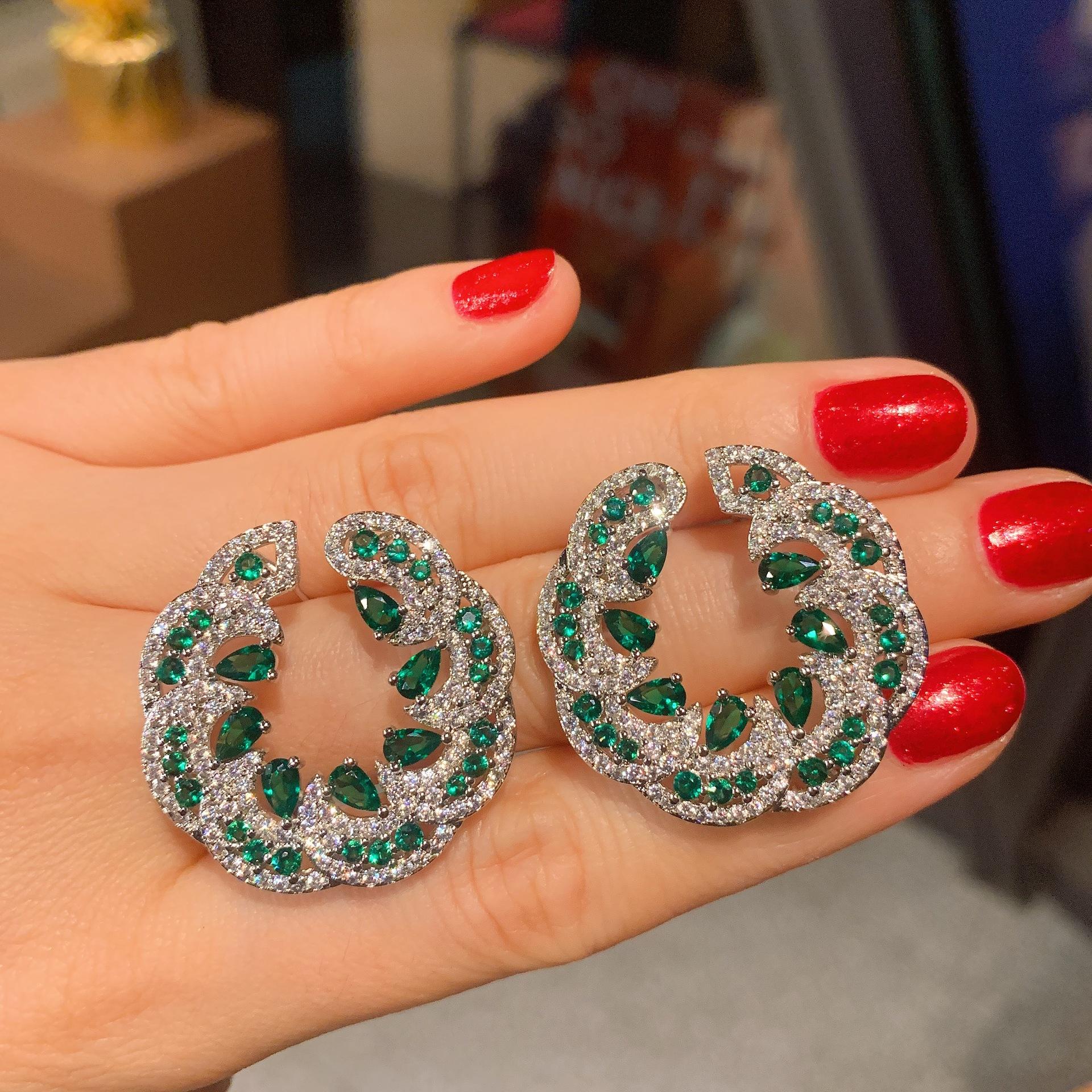 

Korean version of temperament women s earrings, European and American style simulation emerald red treasure exaggerated large stud