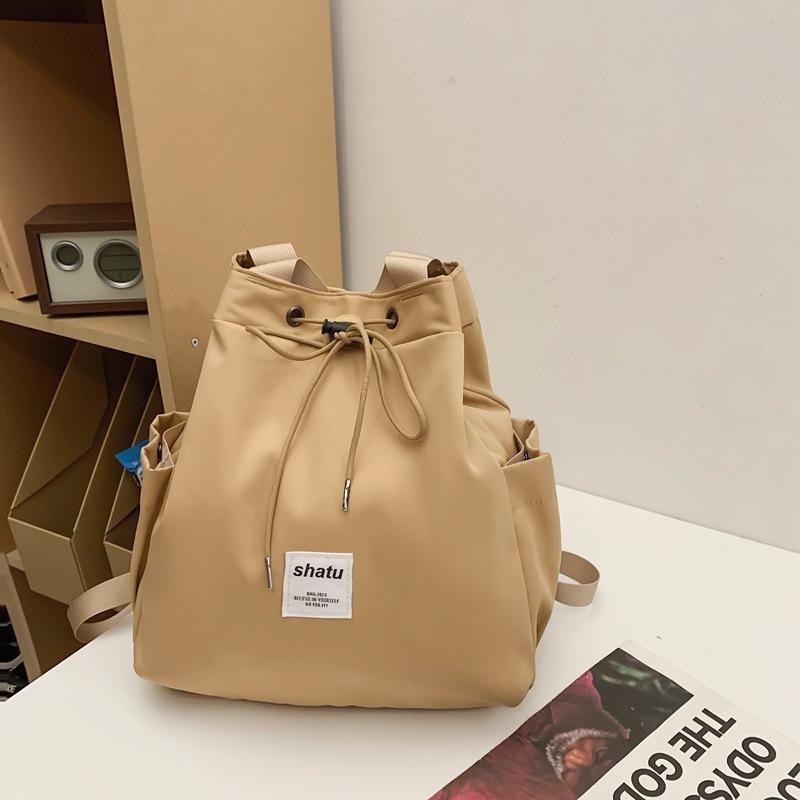 New dual-purpose small backpack, casual niche girlfriend handheld shoulder bag, Japanese and Korean drawstring commuter work backpack