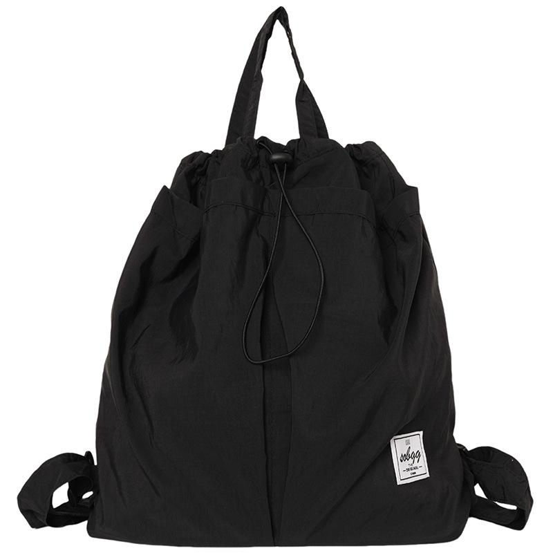 The new Hong Kong wind locomotive drawstring is simple andlarge-capacity leisure. Men and women have the same commuter backpack and student schoolbag.