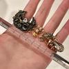 Pendientes de botón Vintage de Luna Dorada con Ángel y Borla de Cristal con Detalles de Esmalte