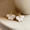 A pair of elegant French-style floral drop earrings, featuring a delicate four-petal flower design, perfect for everyday wear, parties, and vacations.