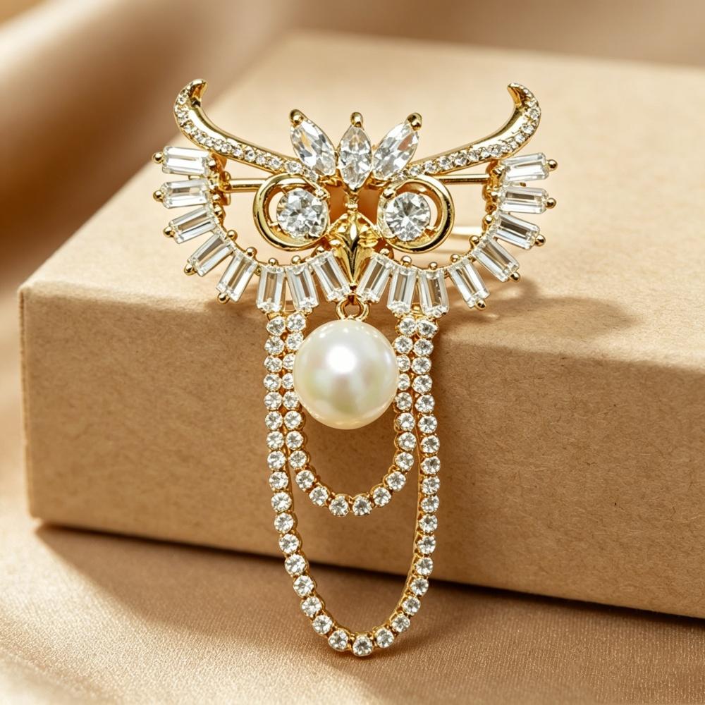 Elegant natural freshwater pearl brooch, shaped like an owl, representing wisdom and foresight.