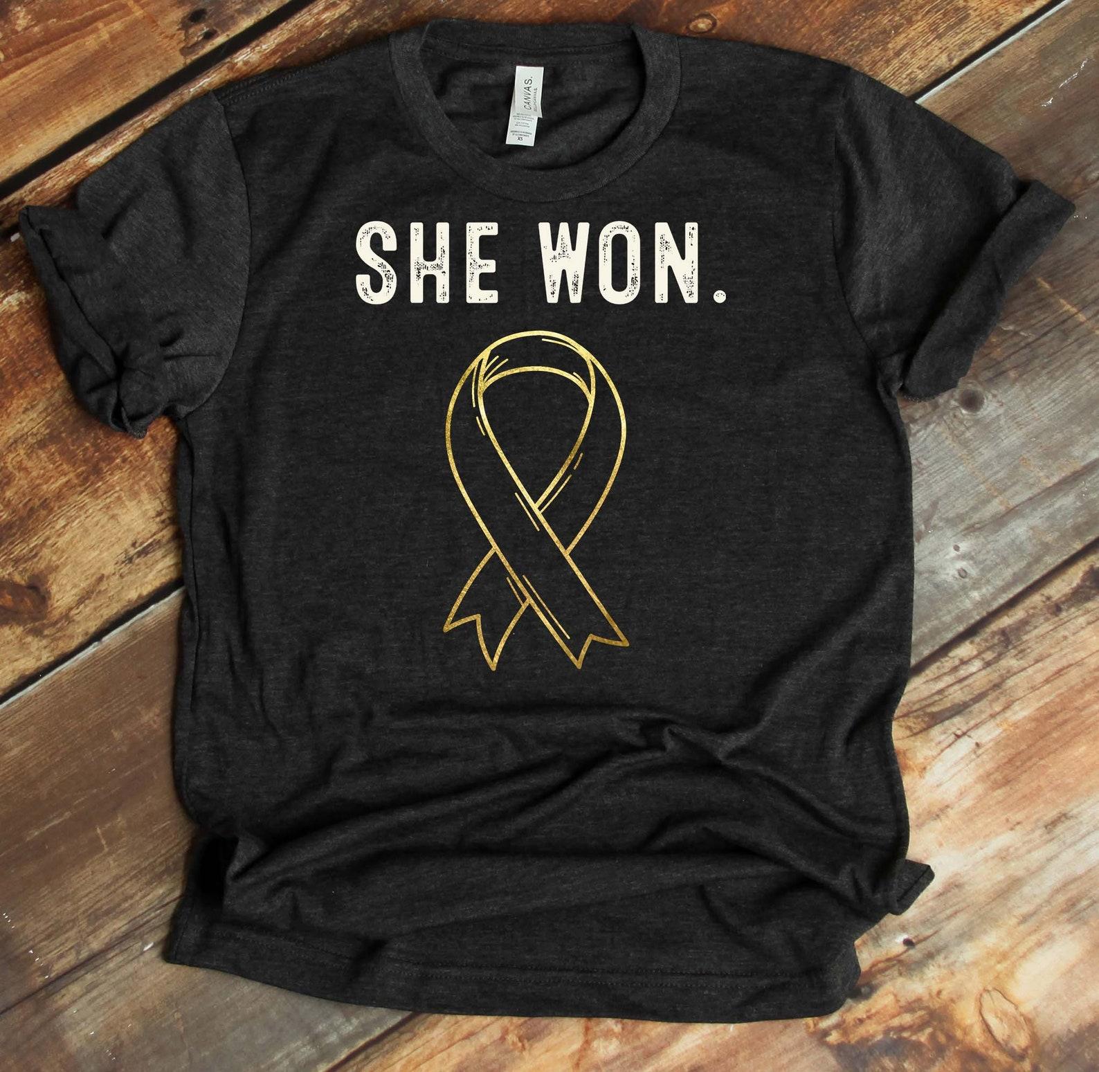 She Won Against Cancer T-Shirt - Big C Warrior - She Beat Cancer - Cancer Survivor - Childhood Cancer Awareness - Gold Ribbon S
