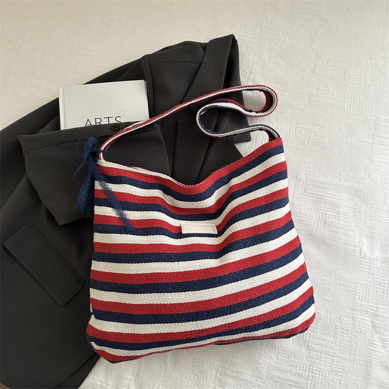 

Полосатая холщовая сумка 2025 Новая Корея Ленивый ветер Сумка-тоут Студенческая Большая вместимость Повседневная сумка через плечо Женская синий