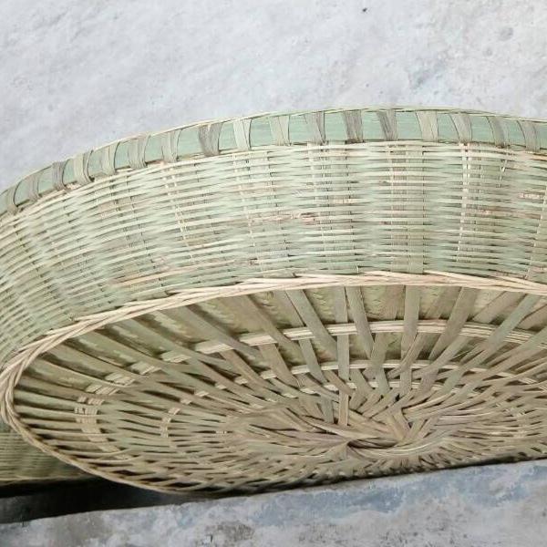 Large Round Bamboo Woven Winnowing Basket with Reinforced Deep Design for Household or Farmhouse Use.