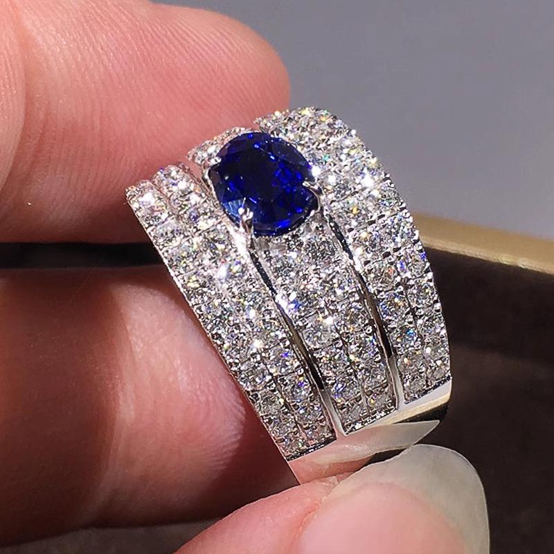 Huitan Funkelnde Damenringe mit ovalem blauem Zirkonia Breiter Ring Wunderschöne Hochzeitsaccessoires Farbe Silber Strahlender Modeschmuck