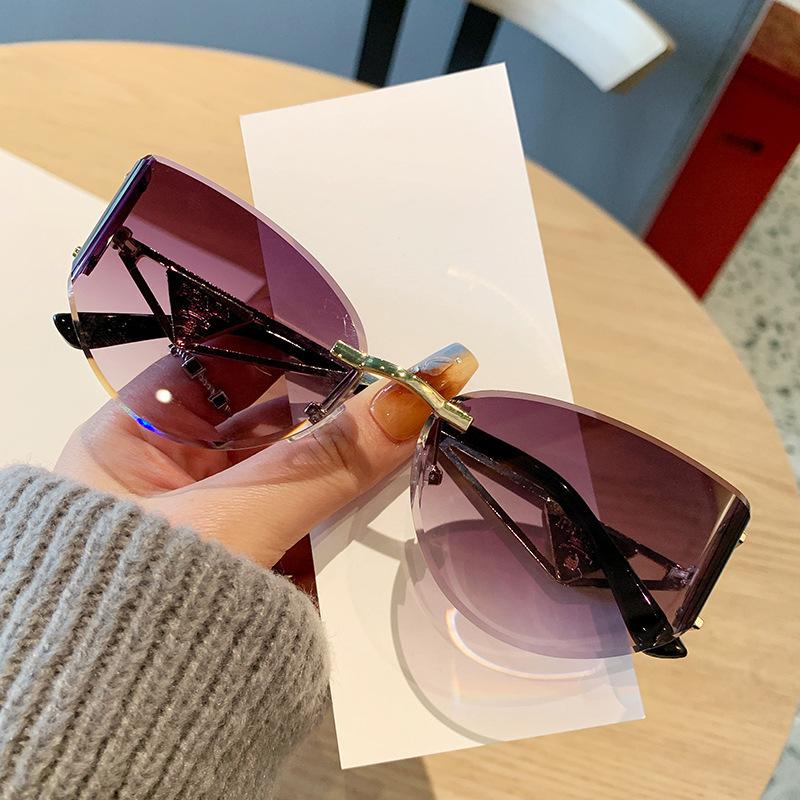 European and American new street photography frameless sunglasses women's hollow metal frames advanced cat glasses sunscreen sunglasses