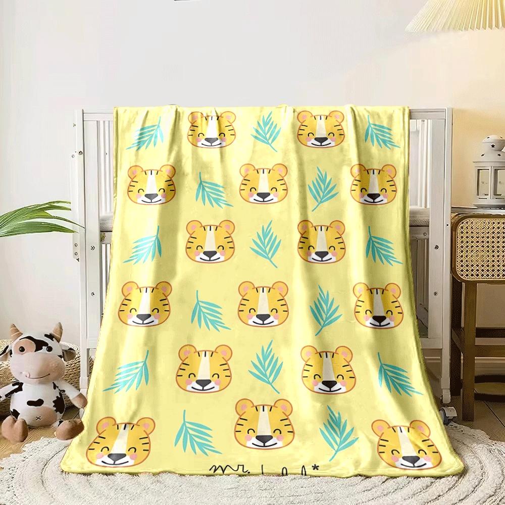 Smiling tiger faces alternate with blue leaves on a yellow background. for all seasons blanket lunch break throw gift 80cm x 120cm