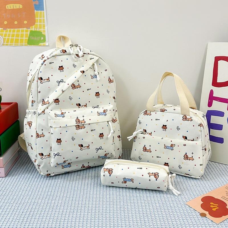 New cartoon printed women's schoolbag, junior high school and primary school students reduce the burden of three-piece backpack, large-capacity