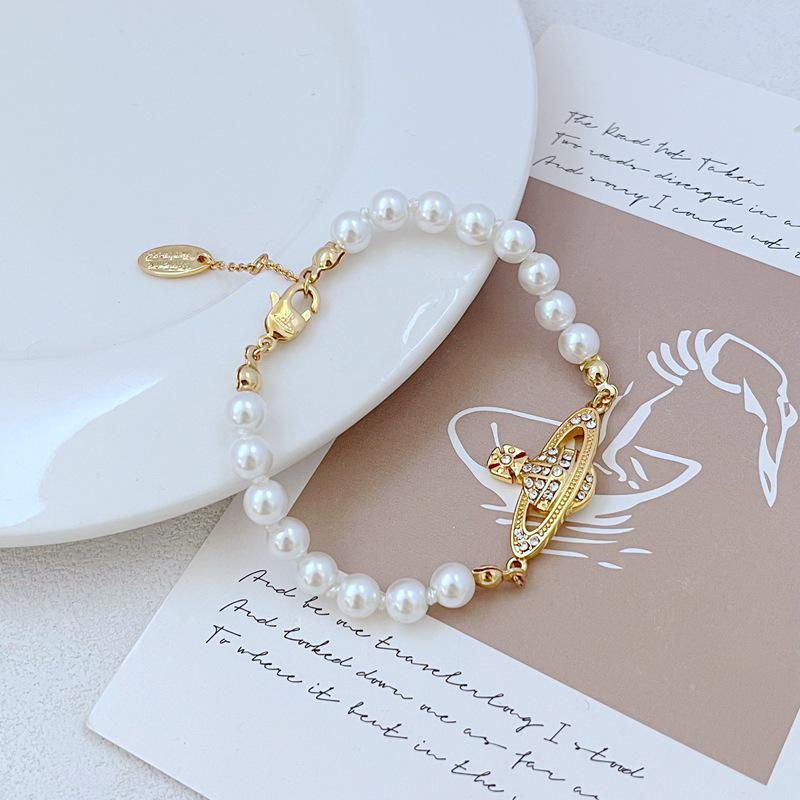 

Luxury Pearl and Zircon Saturn Bracelet золотий