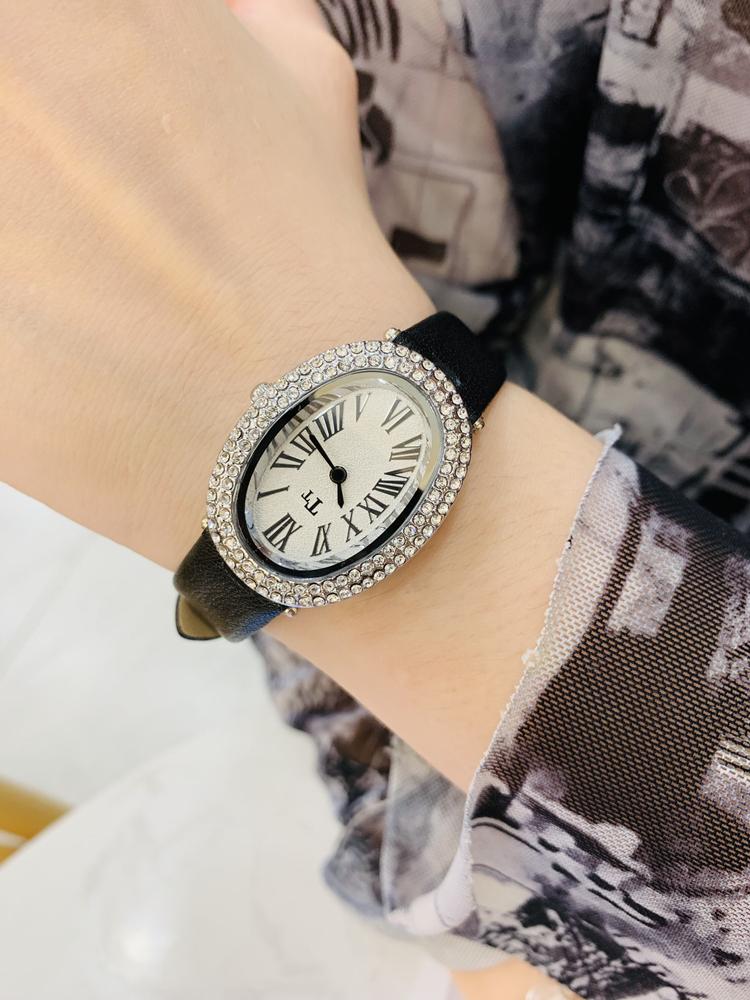 Oval-shaped women's watch with a vintage, luxurious feel and a high-end leather strap; fashionable quartz wristwatch.