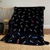 Fish bone patterns with scattered colorful accents on a black background. for all seasons blanket lunch break throw gift