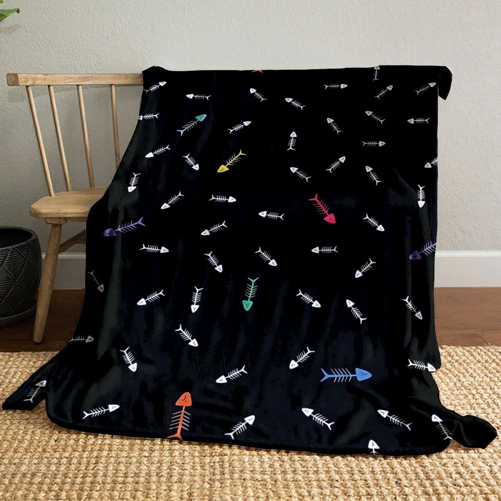 Fish bone patterns with scattered colorful accents on a black background. for all seasons blanket lunch break throw gift