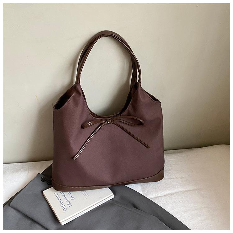 Retro commuter niche bow single shoulder armpit bag 2025 Korean version new fashion simple contrasting color tote bag