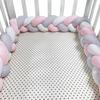 Three-strand knitted crib bumper, cable knit crib bumper