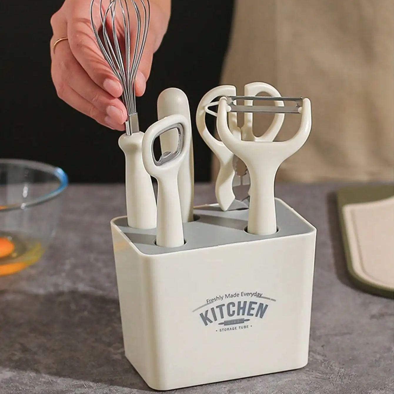 

A 6-piece kitchen tool fruit slicer set with storage holder, melon planer, scissors, bottle opener, and egg beater set