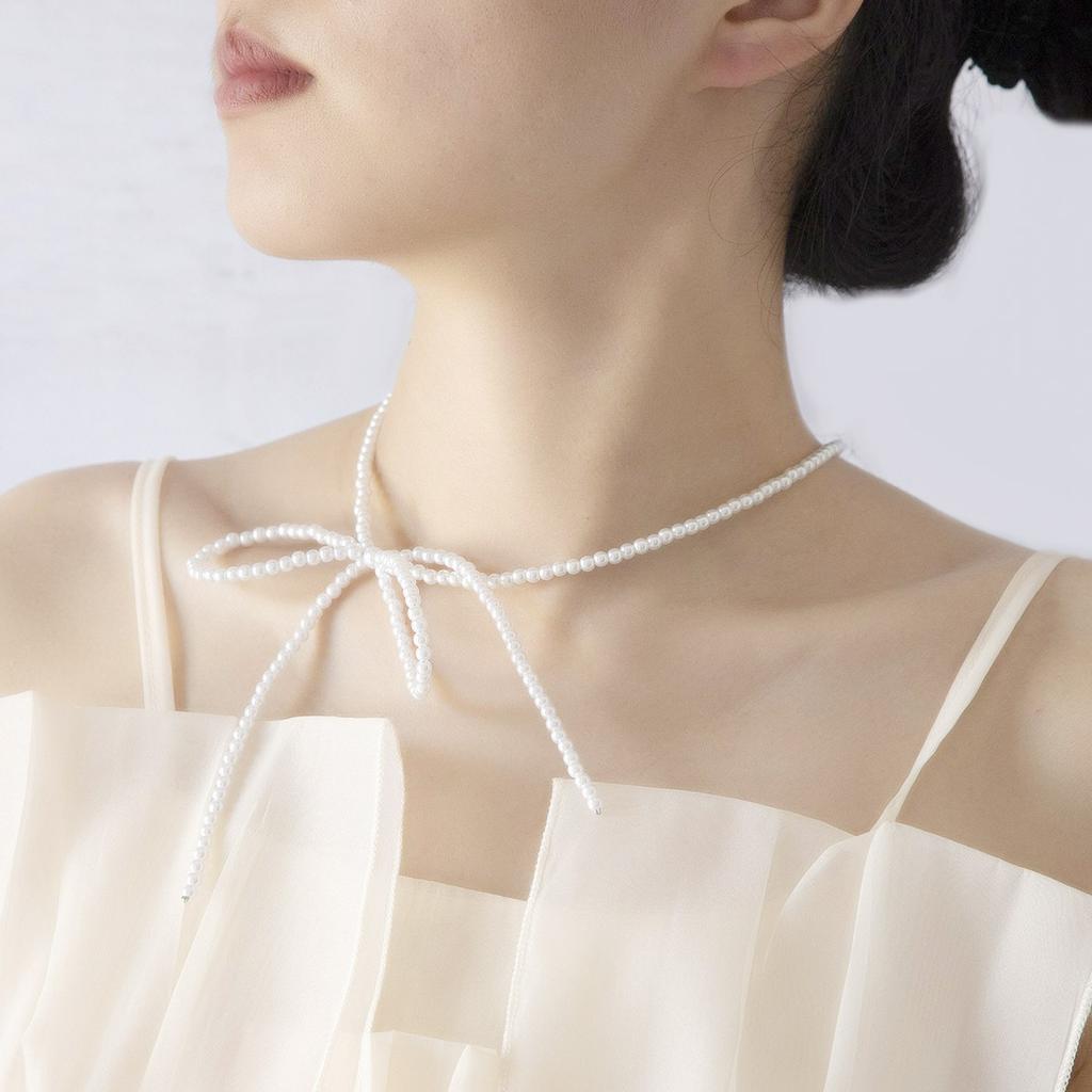 Korean version of simple niche imitation pearl fugitive princess bow necklace clean super fairy ballet style collarbone chain