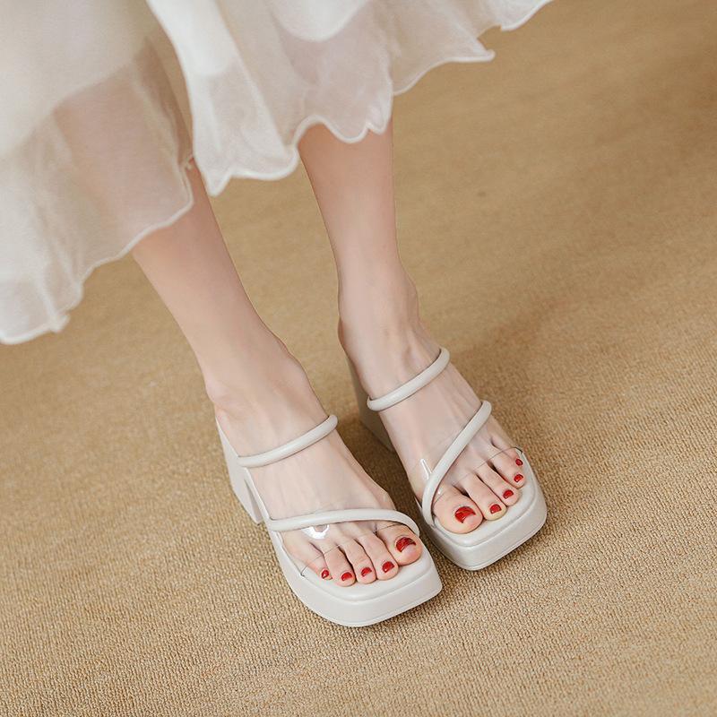 Open-toed thick-soled outer slippers women's fashion muffin one-word drag new summer transparent high-heeled fairy sandals