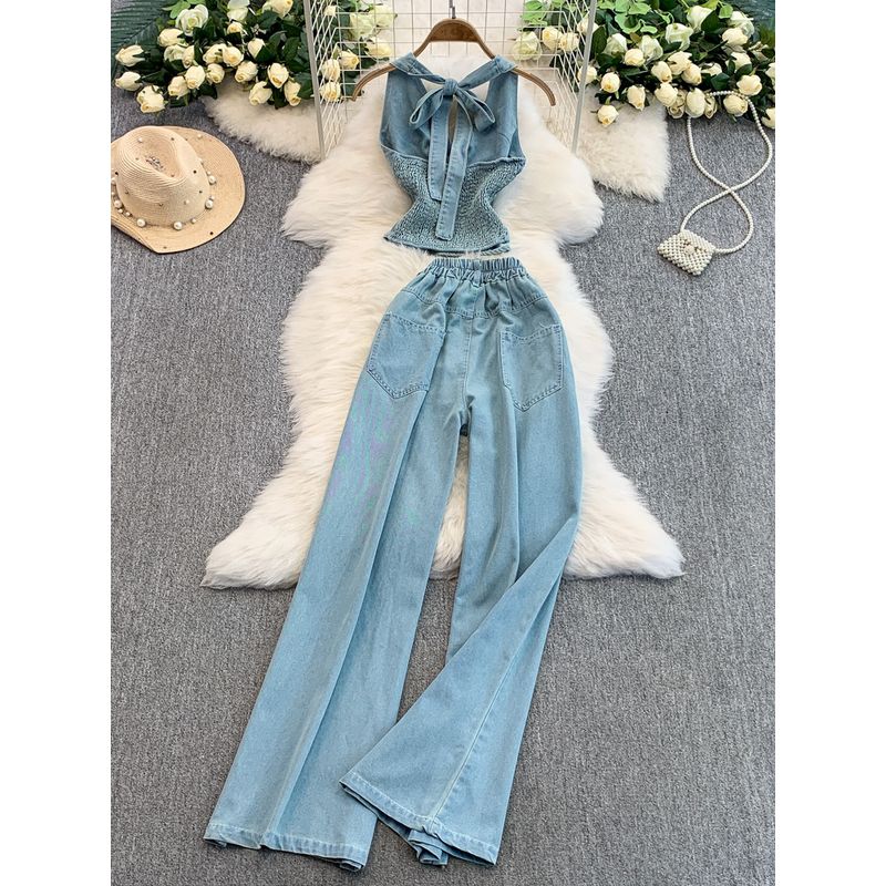 European and American Sexy V-neck Twist Waist Hugging Hanging Neck Denim Vest Top + High Waist Slimming Flared Wide Leg Trousers Set