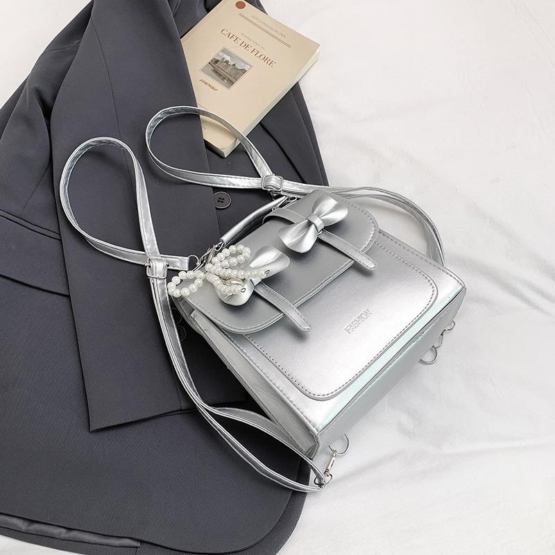 South Korea solid color college style commuter backpack women 2025 new trend bow portable shoulder messenger bag