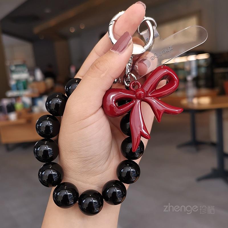 

Butterfly love round bead mobile phone chain ins fashion women s hand chain wrist pendant bead pendant bag pendant [black] hollow bow beaded bracelet