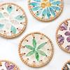 The hand - made rattan - edged shell coasters add a unique marine style to the tabletop.