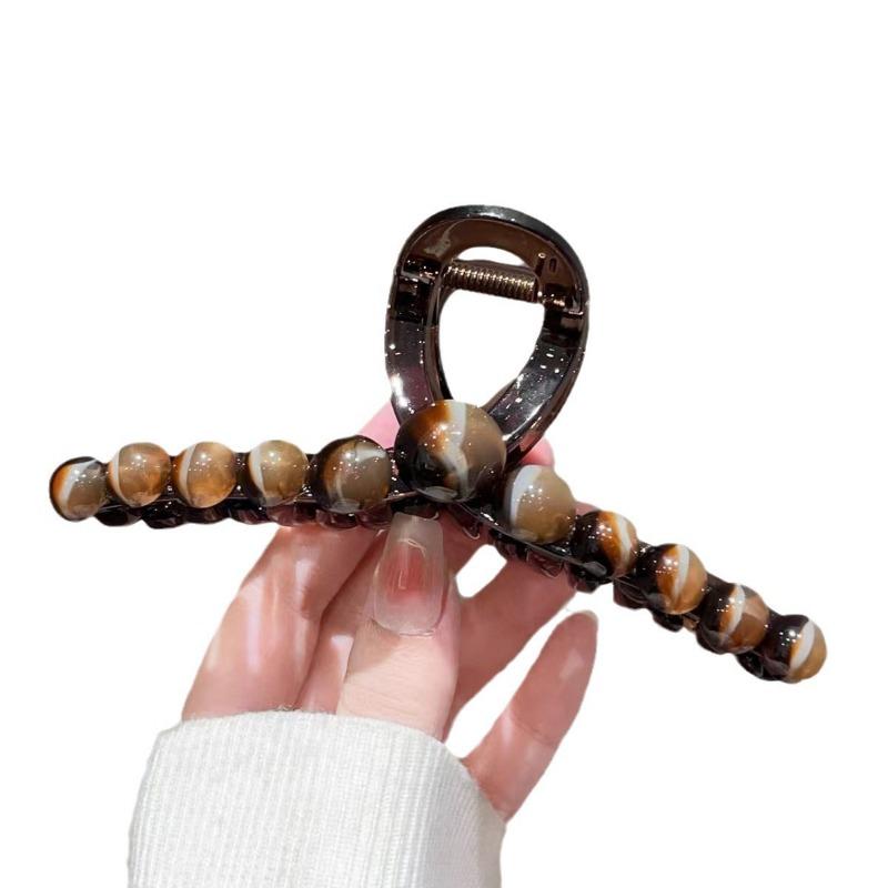 A Gradient Round Bead Shark Clip A Large Hair Clip and A Hairpin for The Back of A Woman's Head