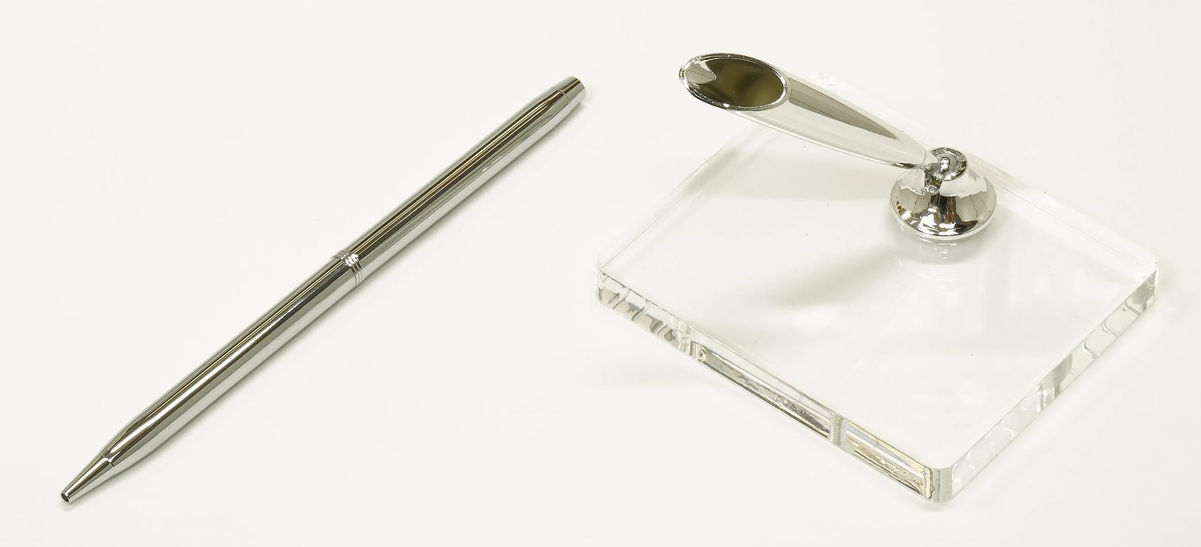 

A brass rotating pen holder with a hole at the top for attaching gimmicks and a clear acrylic pen stand with a silver pen holder (Q-S6P3-1)