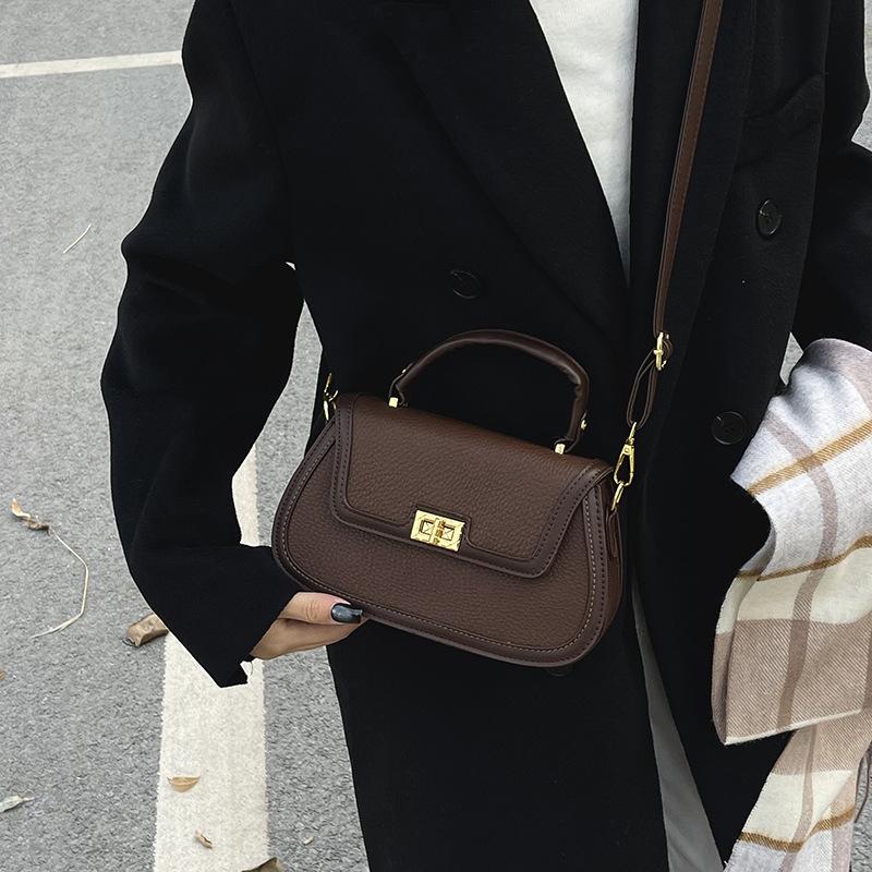 Spring niche design fashionable contrasting color saddle bag portable shoulder crossbody trendy women's bag