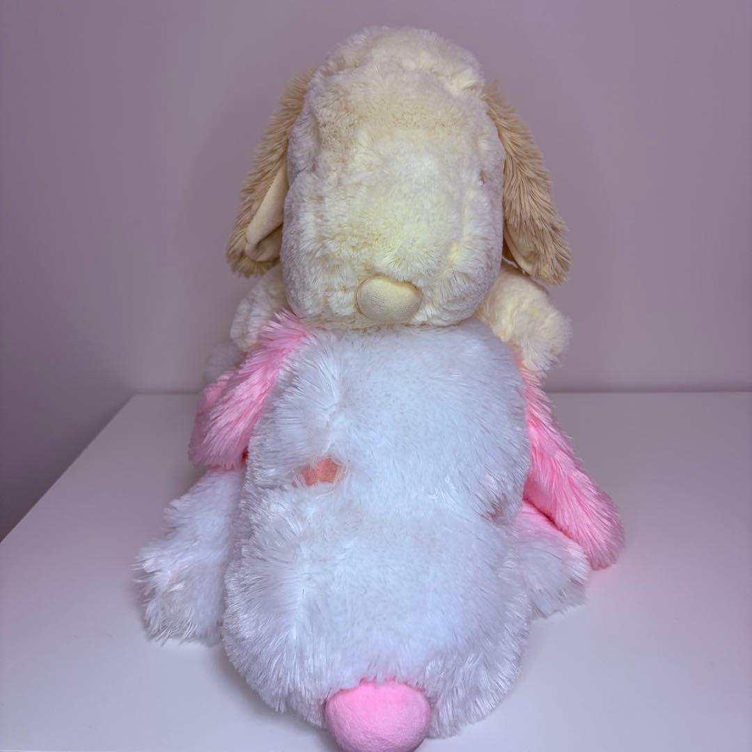 Snoopy stuffed toy pink white lying down