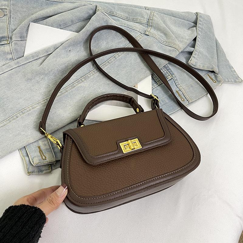 Spring niche design fashionable contrasting color saddle bag portable shoulder crossbody trendy women's bag
