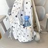 Star-Printed Backpack with Front Zipper Pocket and Tassel Details for School and Daily Use