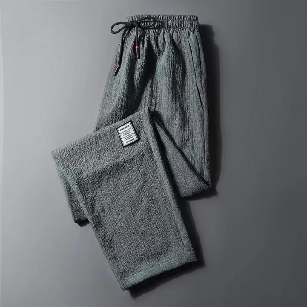 Męskie spodnie casualowe ze ściągaczem w pasie i modnym wzorem Harlan Pants Sportowe luźne spodnie w jednolitym kolorze