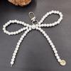 Fashionable Korean-inspired blogger-style large pearl bow mobile phone pendant key chain with heart design.