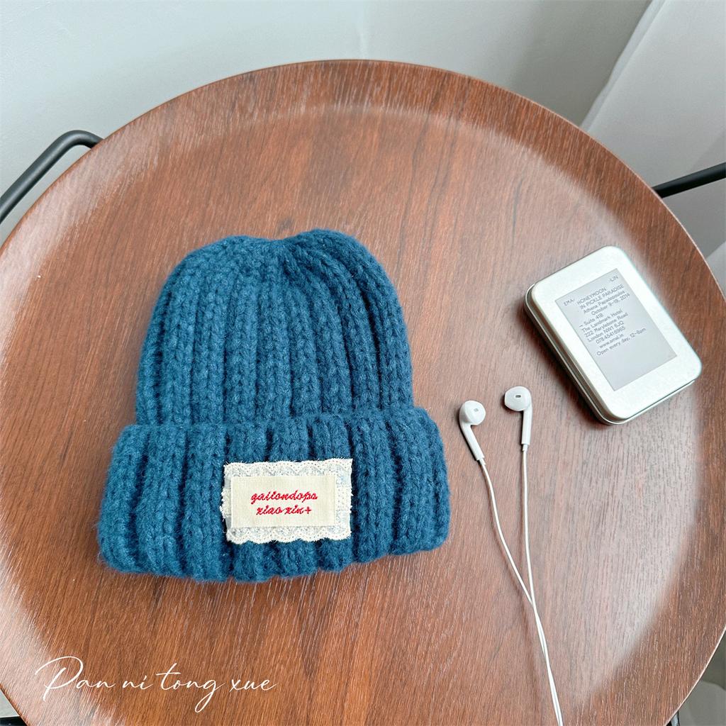 Neue Spitze Etikett Kinder Wollmütze Nuojiji Student Herbst und Winter Neu Warm und Vielseitig Ohrenschutz Strickmütze
