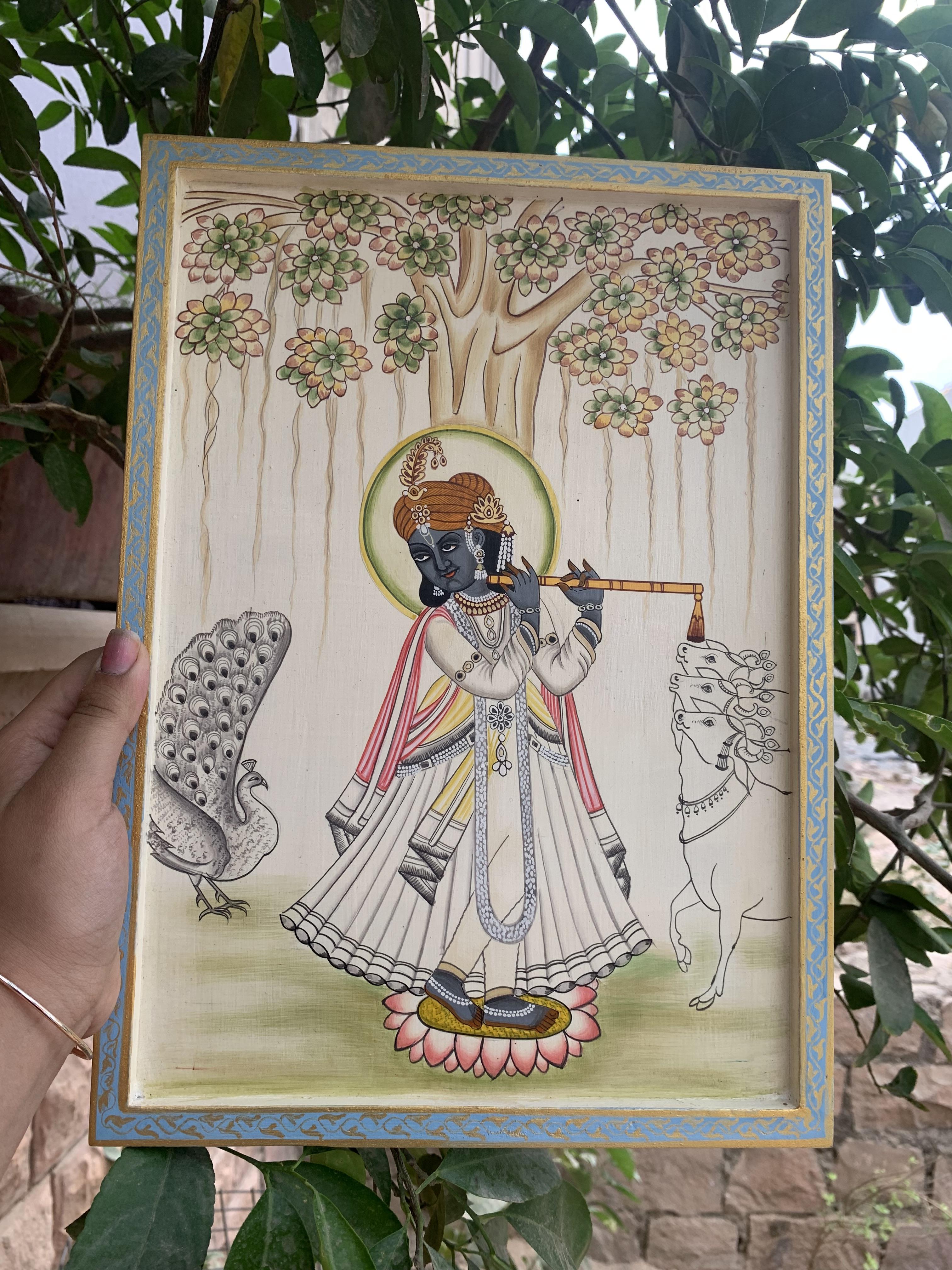 

Hand-Painted Krishna Flute Player Wooden Wall Hanging: Indian Peacock Cow Decor 14” X 1” X 10” ( h x w x l) approx.