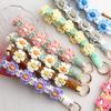 Lanière de poignet tissée à la main avec des fleurs pour téléphone portable Lanière de poignet Porte-clés Sangle d'accrochage Porte-clés Fleur de marguerite Fleurie Corde pour téléphone floral