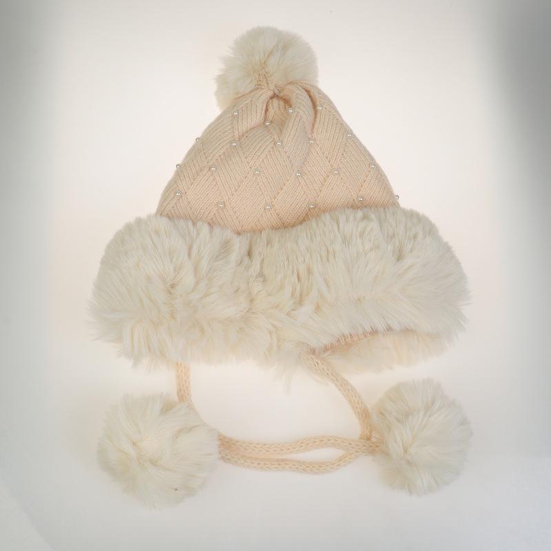 Winter Women's Knitted Hat with Beads and Fur Pom, Featuring a Velvet Lining, Large Fur Brim, and Warm Ear Protection.