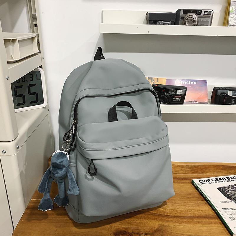 Casual large-capacity backpack fashionable outdoor lightweight junior high school students solid color simple schoolbag Korean version travel backpack