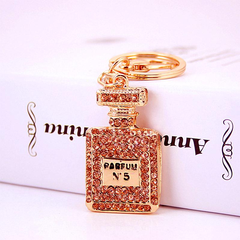 Elegant Diamond-Studded Four-Leaf Clover Keychain: Perfume Bottle Bag Charm for Women