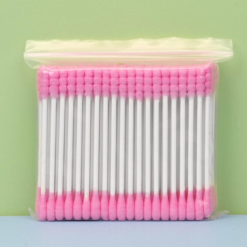 Pack of 100 double-ended, disposable cotton swabs with paper sticks for ear cleaning and makeup application.