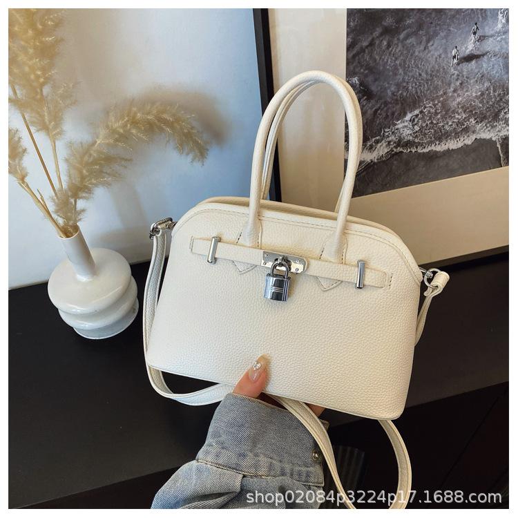 2025 new women's lychee pattern solid color lock shoulder bag temperament niche versatile commuter portable messenger